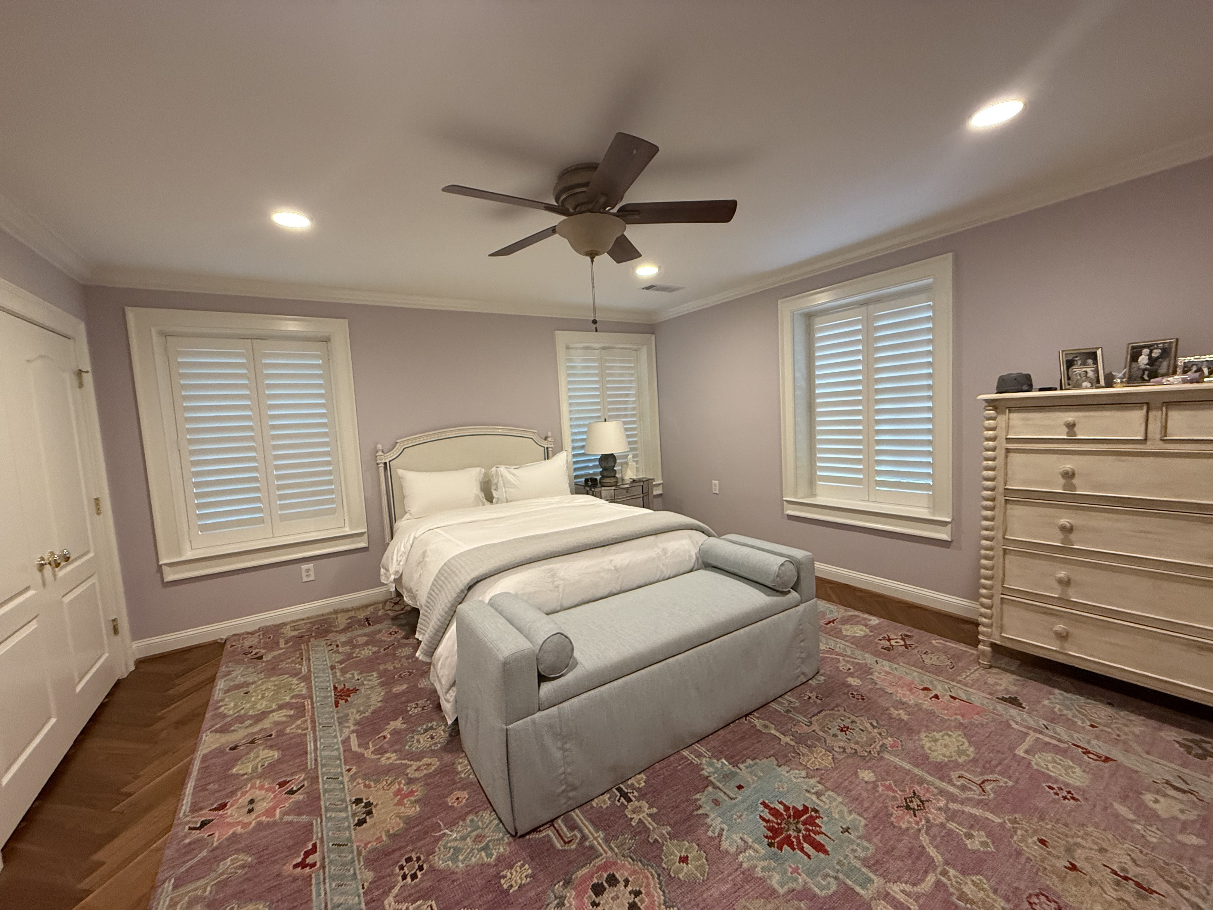 Plantation shutters in a soft-lit bedroom
