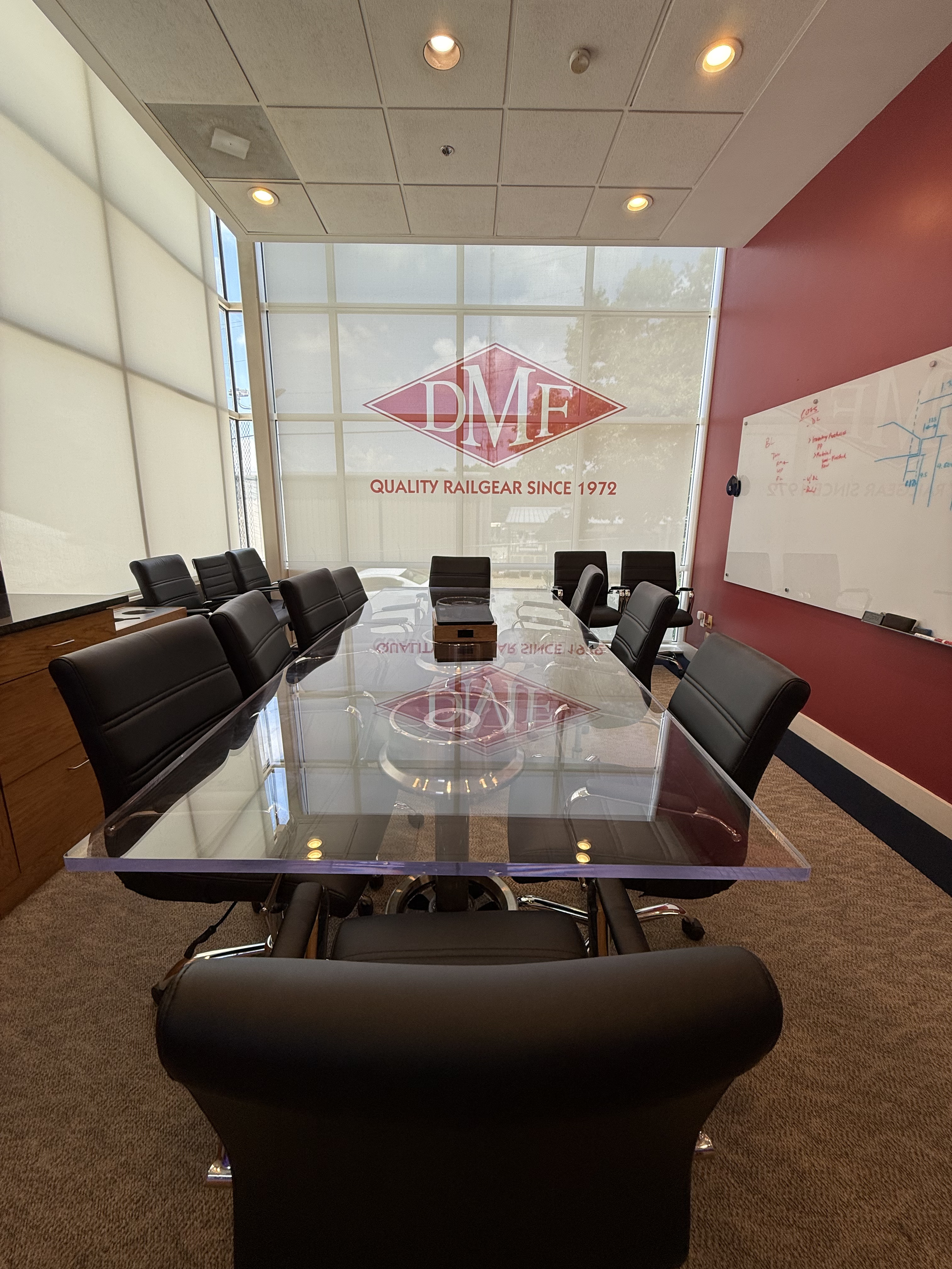 Custom logo-printed solar shade in a conference room