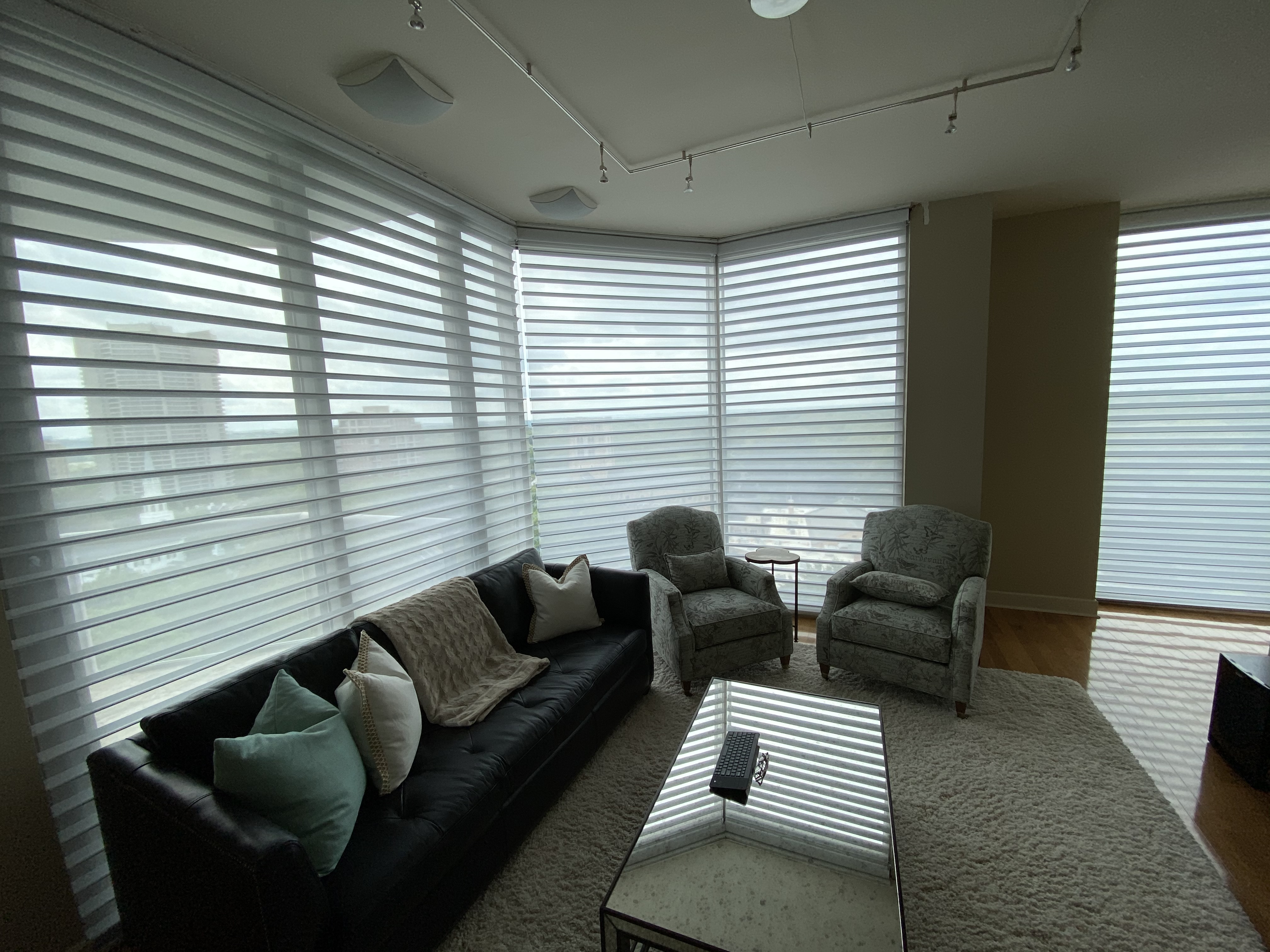 Silhouette horizontal sheers wrapping a corner window wall